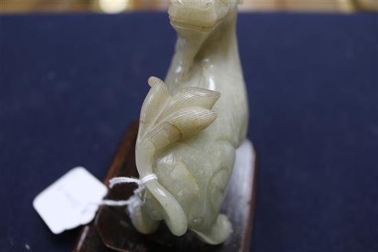 Two Chinese celadon jade figures of a fisherman and a lion-dog, 6.2 and 11cm, wood stands